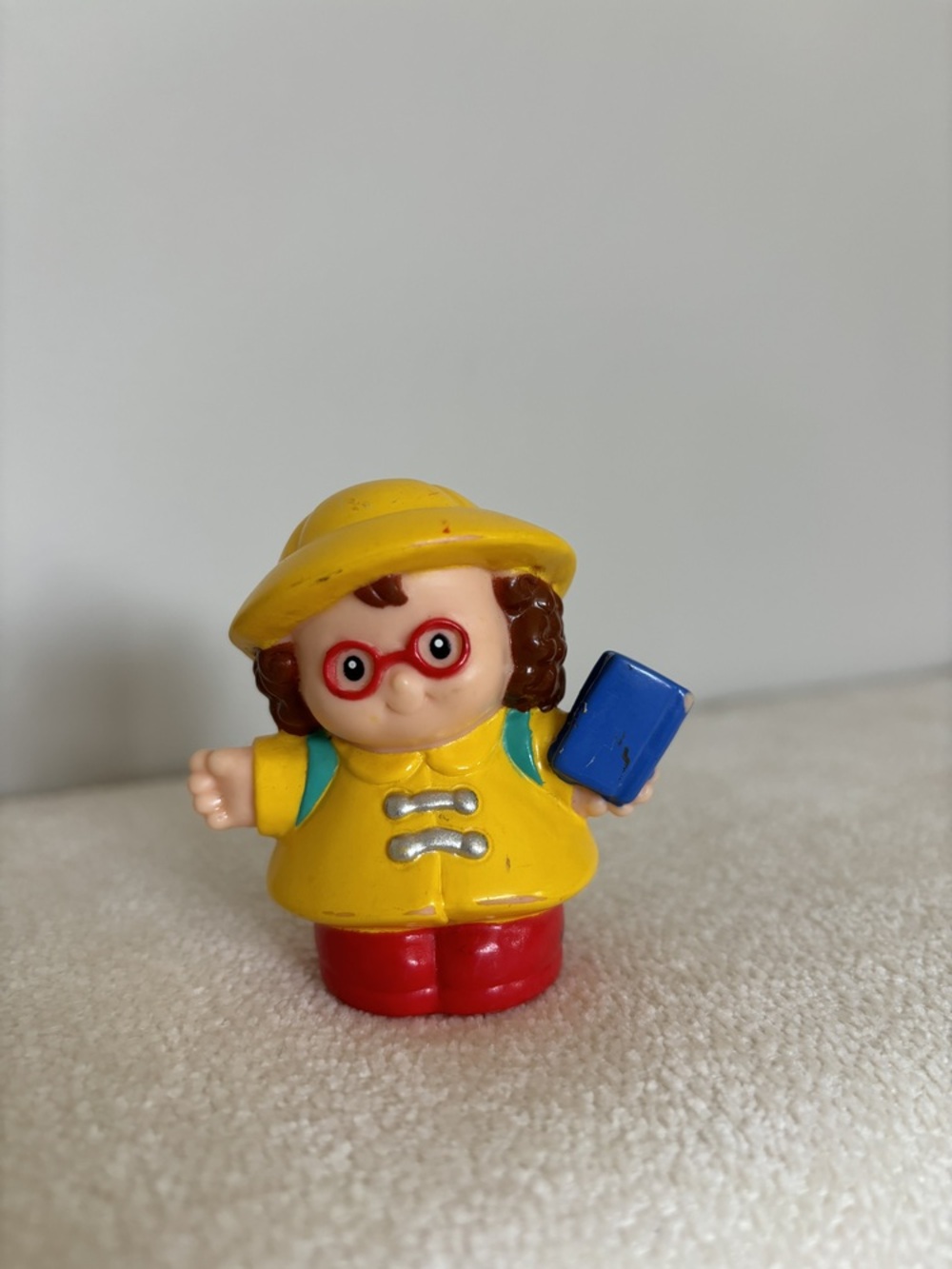 Little people girl with a book/backpack